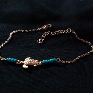 Gold "turtle" with blue beads